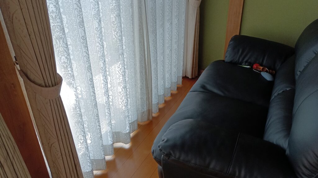 縁側のソファーと陽射しがこぼれるレースカーテン